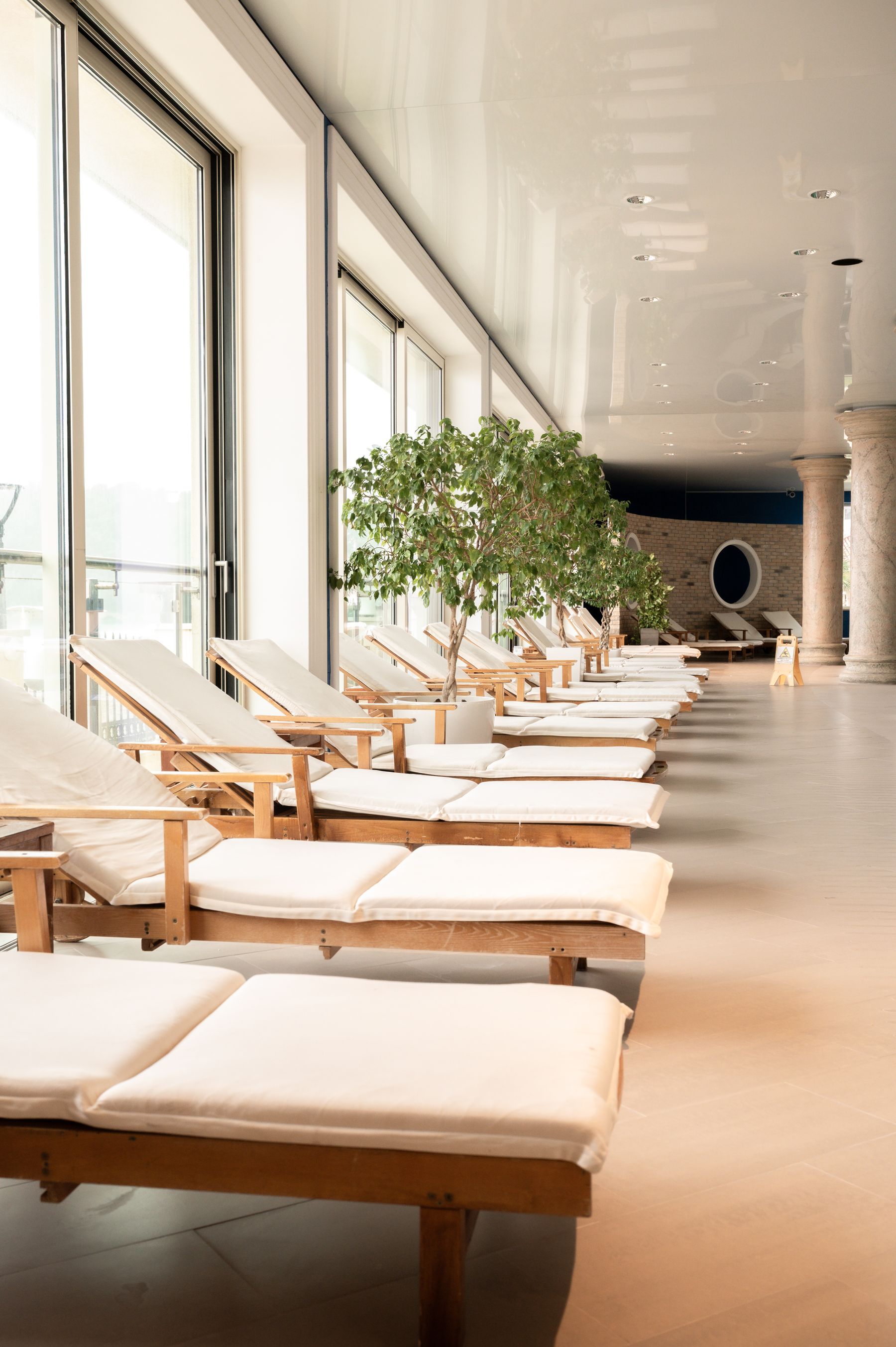 Sunlit wellness lounge with natural wood daybeds